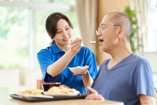 care giver feeding senior food